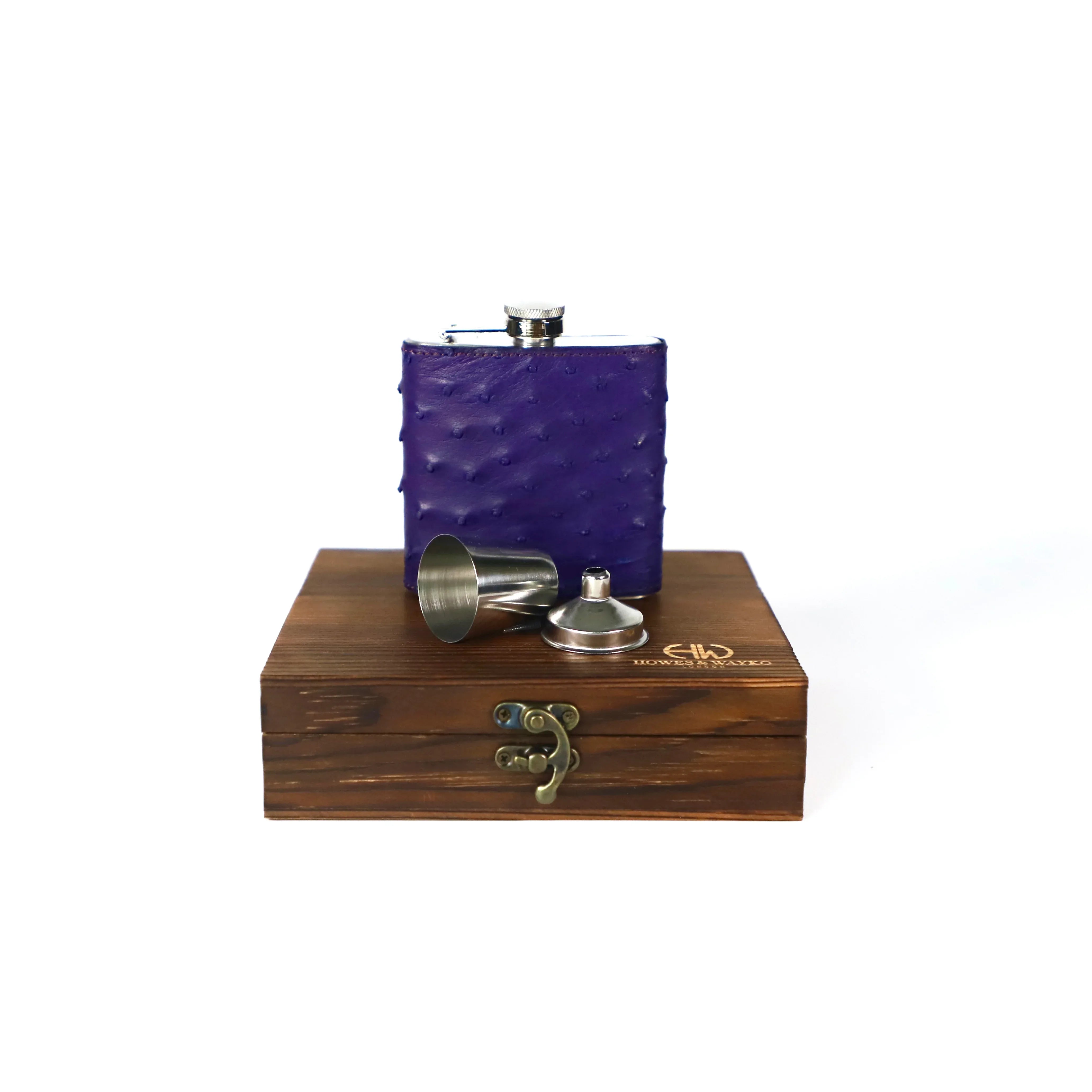Purple Ostrich flask displayed on top of a wooden gift box on a white background