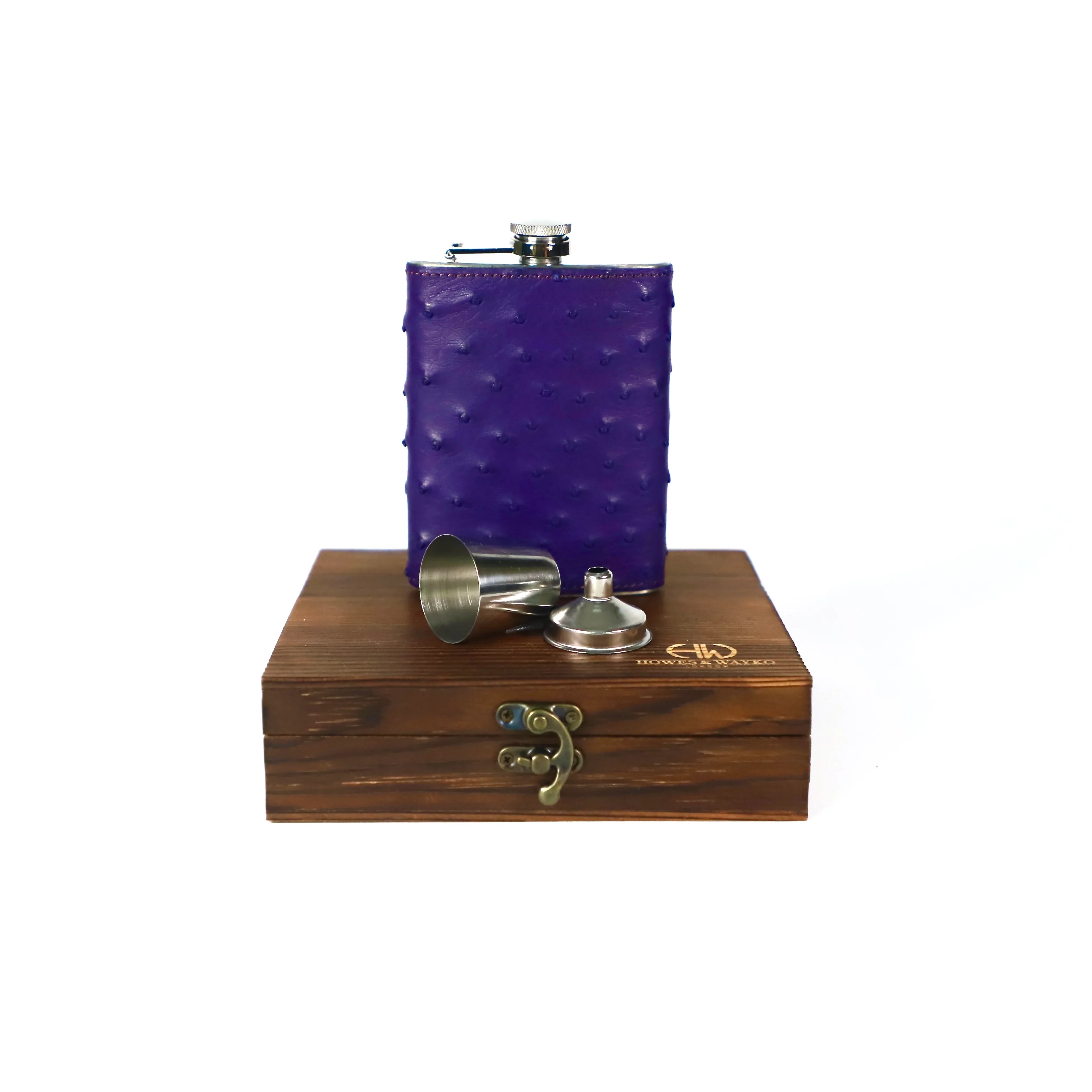 Purple Ostrich flask on top of a wooden gift box with a white background