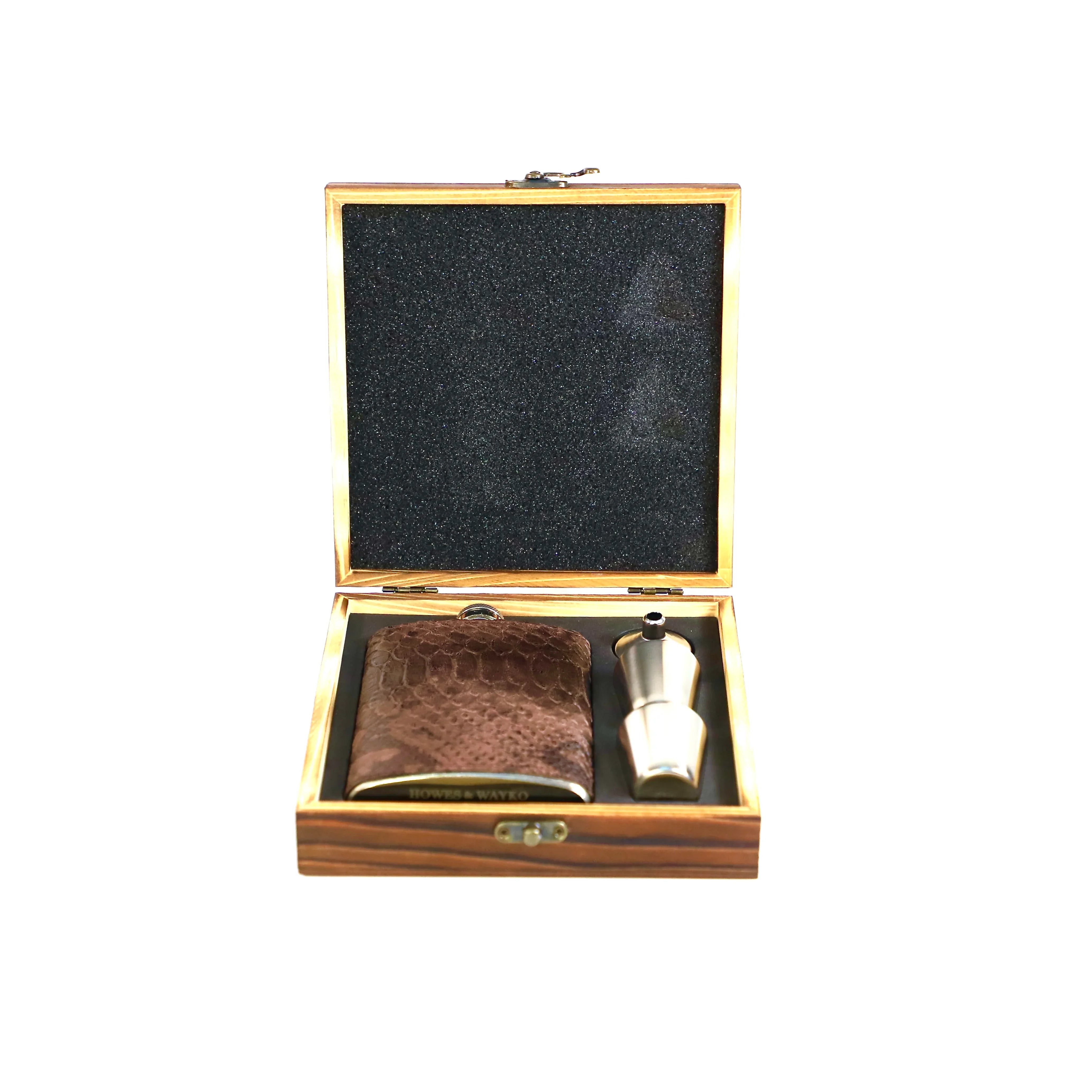 Stainless flask covered in a brown snake effect leather, displayed in a wooden gift box with a white background.