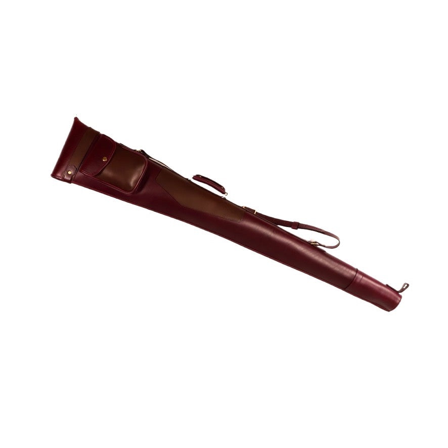 Purple vegetable-tanned leather range slip with chocolate brown pocket, sheepskin lining and brass hardware on a white background