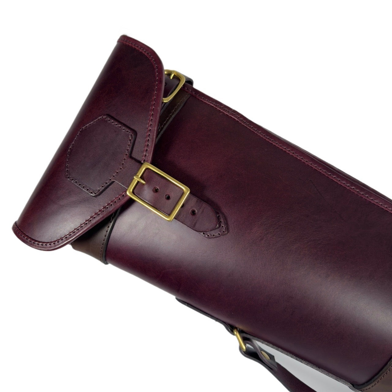 Premium two-tone leather range slip with sheepskin lining and brass fittings on a white background