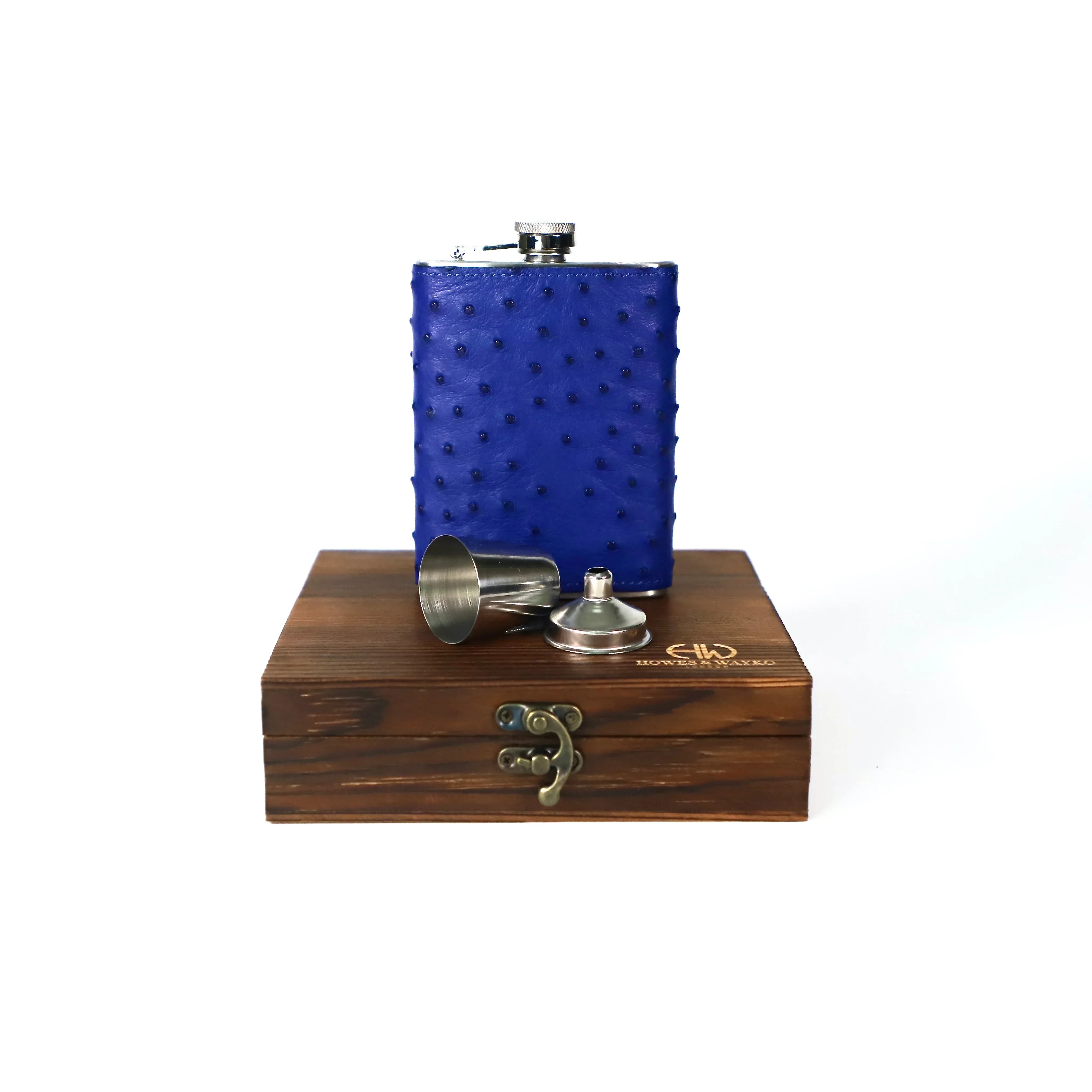 Blue textured flask with silver cap and funnel on a wooden stand with 'G&F' branding.