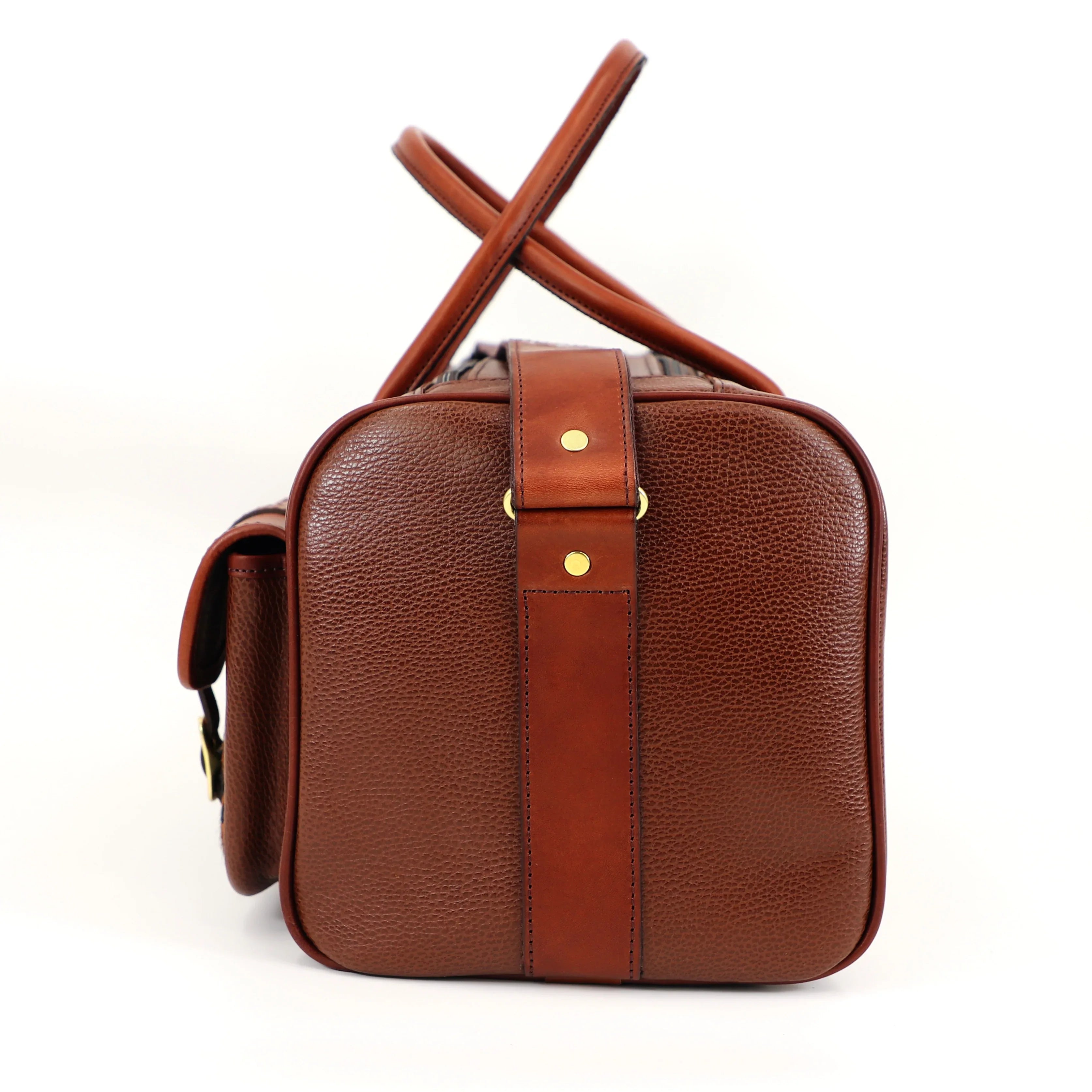 close up of caramel leather range bag brass finishes