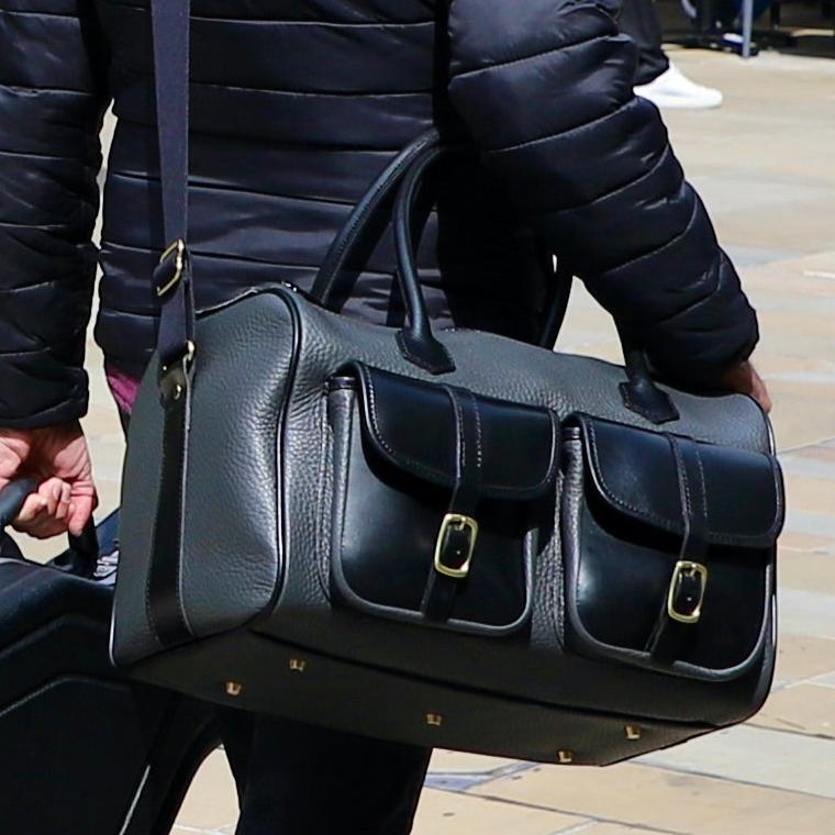 British Made Erin Greyson - Leather Range Bag adorned on a person wearing the strap around them and walking in public, using the leather range bag casually