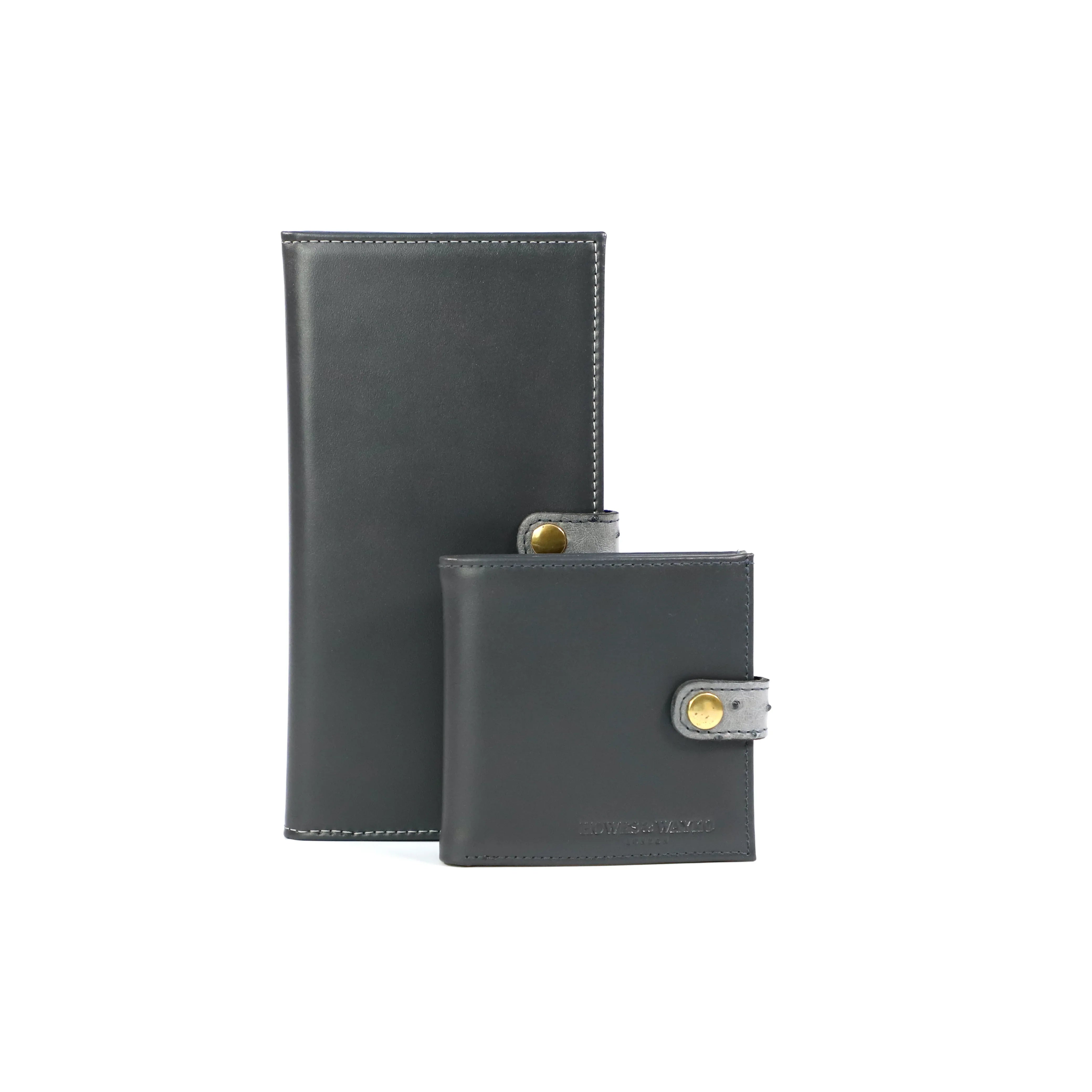 Two Grey leather shotgun certificate wallet, finished with a grey Ostrich clasp with a gold fastener a white background
