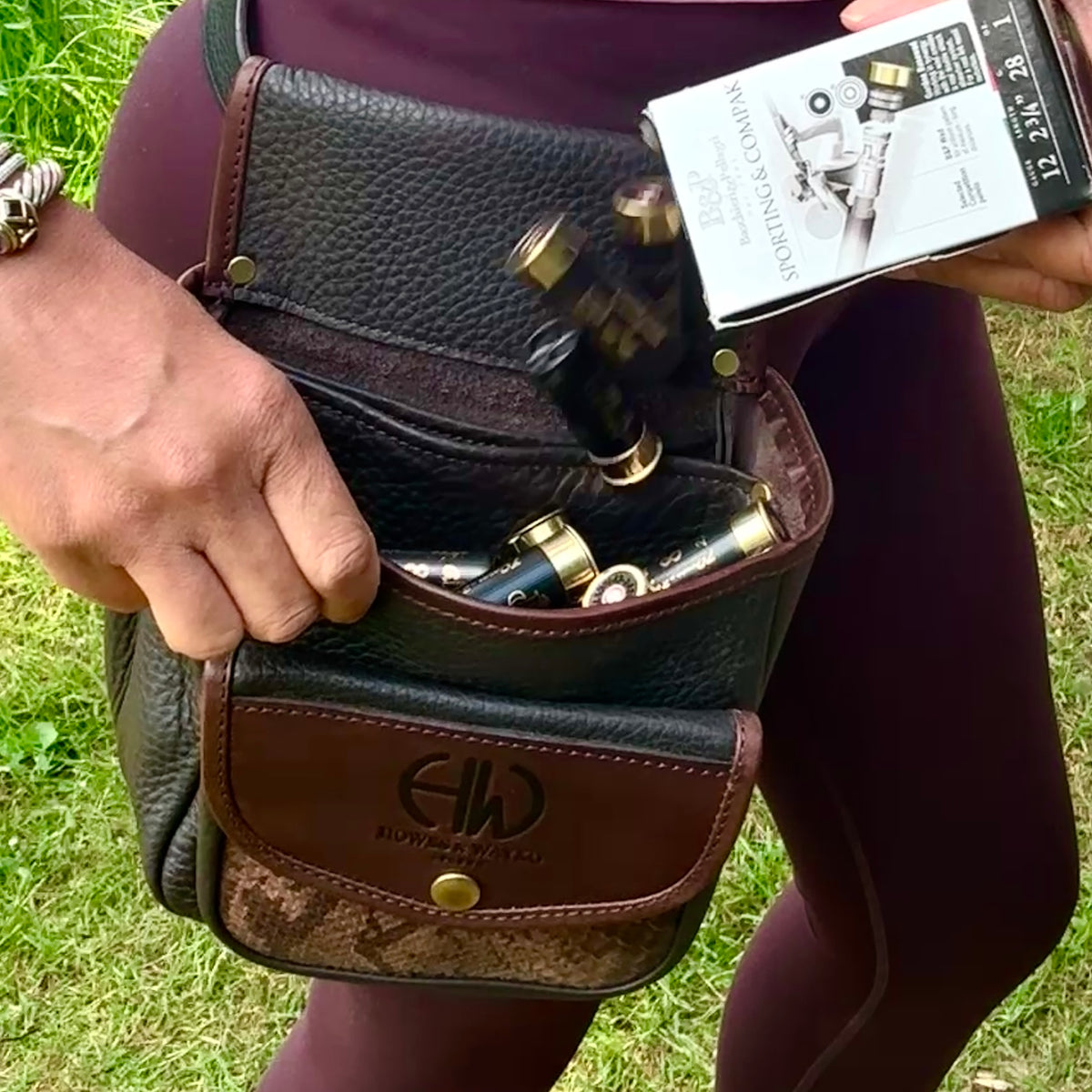 Person wearing a leather howes and a wayko belt, a Howes and wayko snake effect cartridge pouch in a grassy area