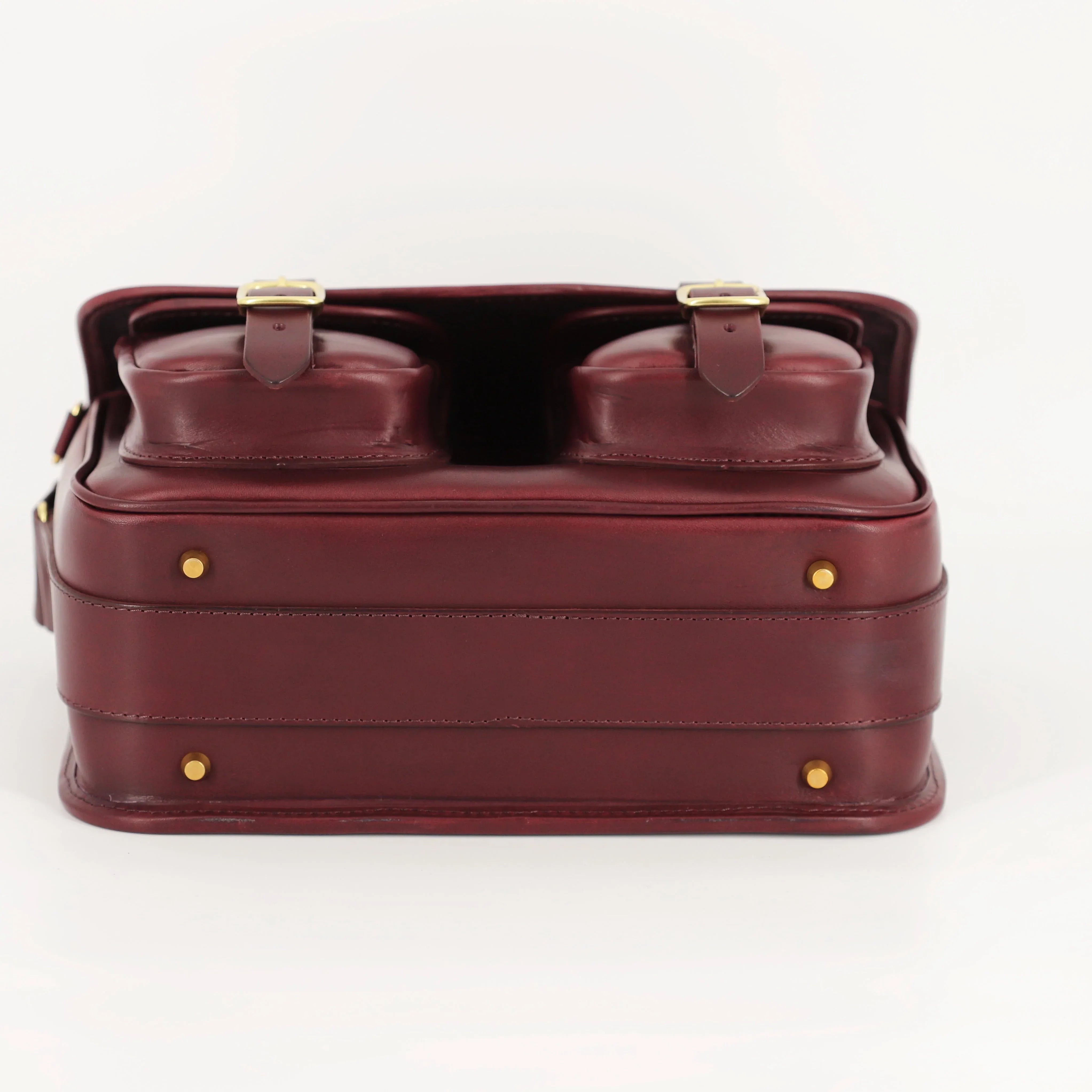 classic style leather range bag bottom view with front pockets with brass buckles