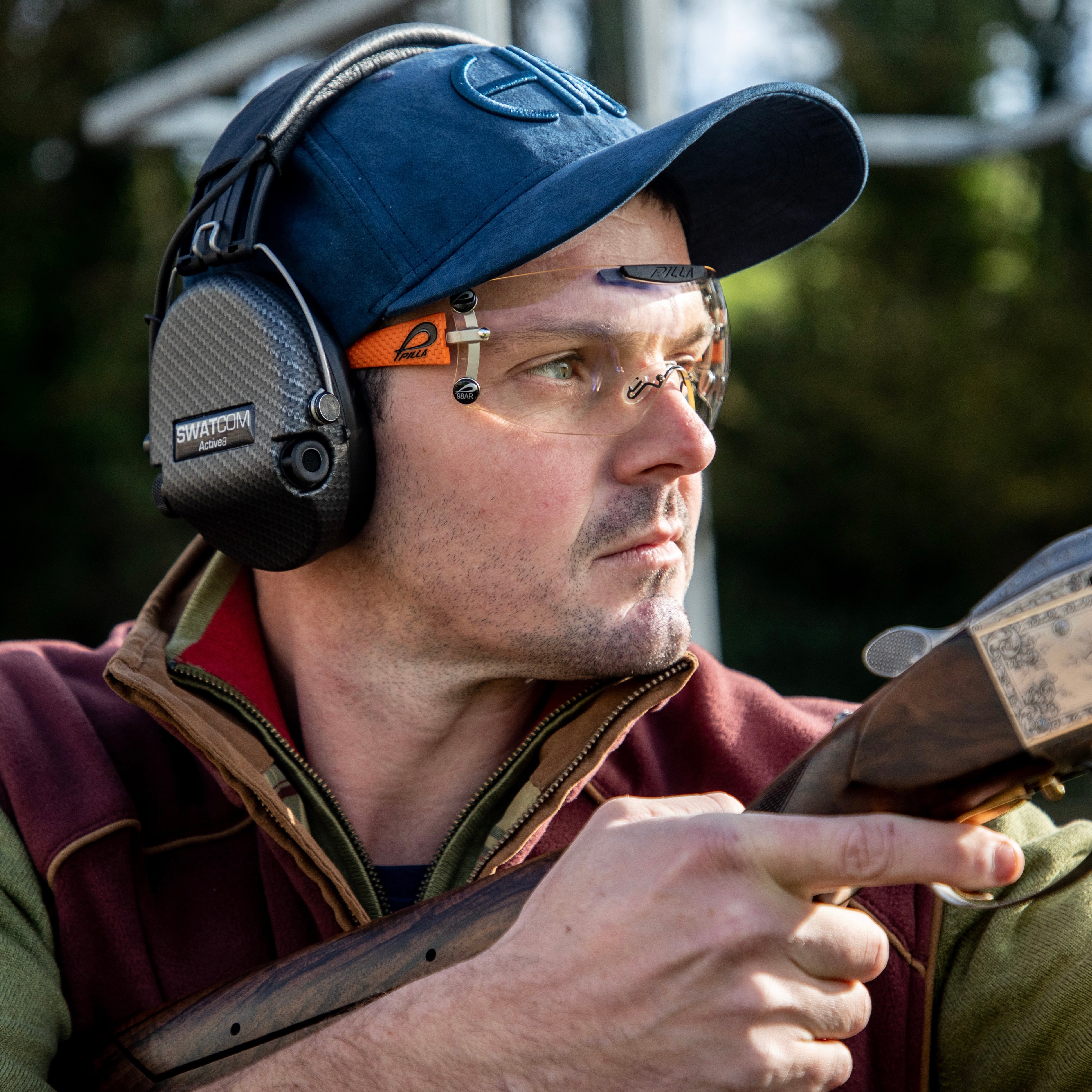 Guy Franklin out at the range wearing his Blue howes and wayko baseball cap
