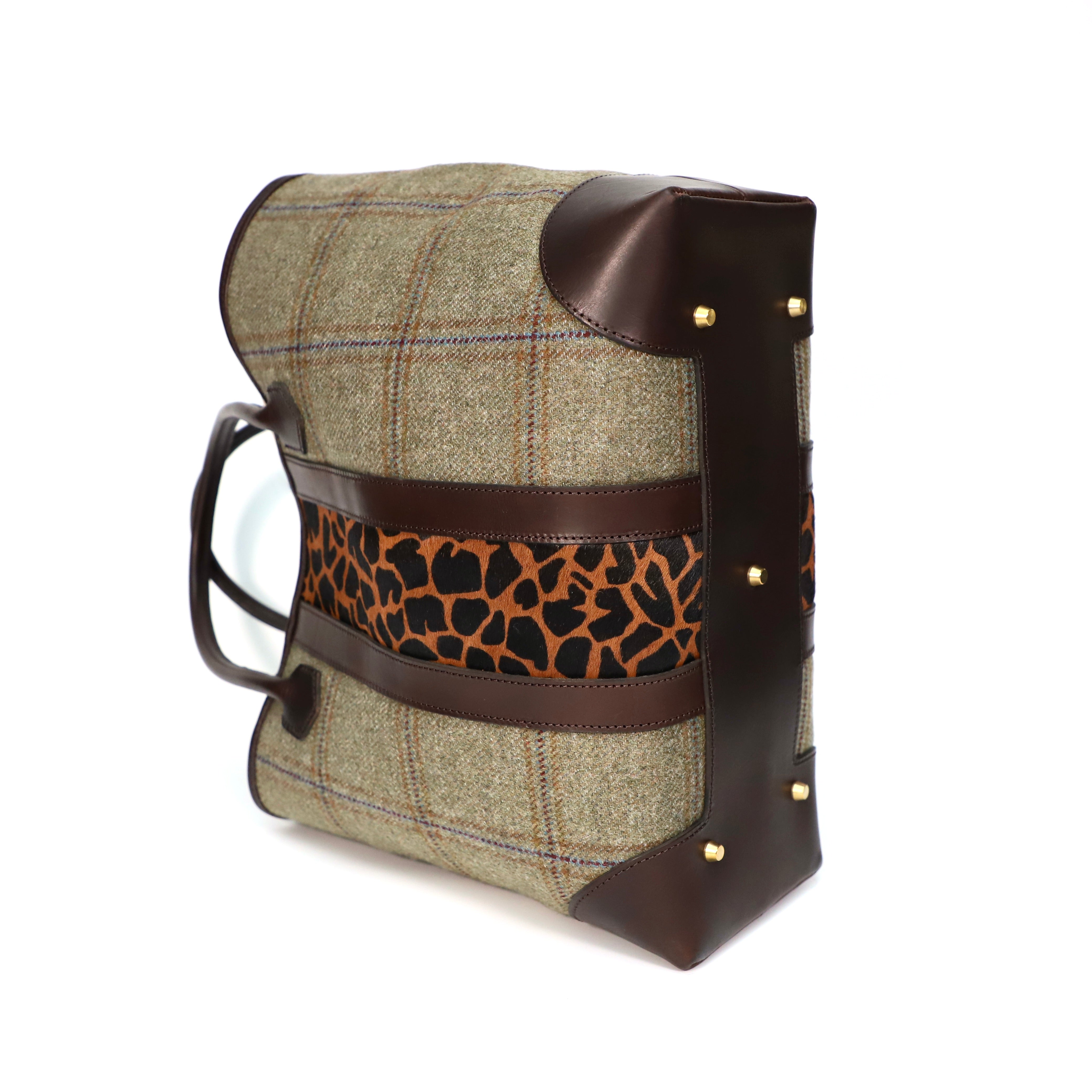 Handbag with green check tweed and Giraffe print accents on a white background