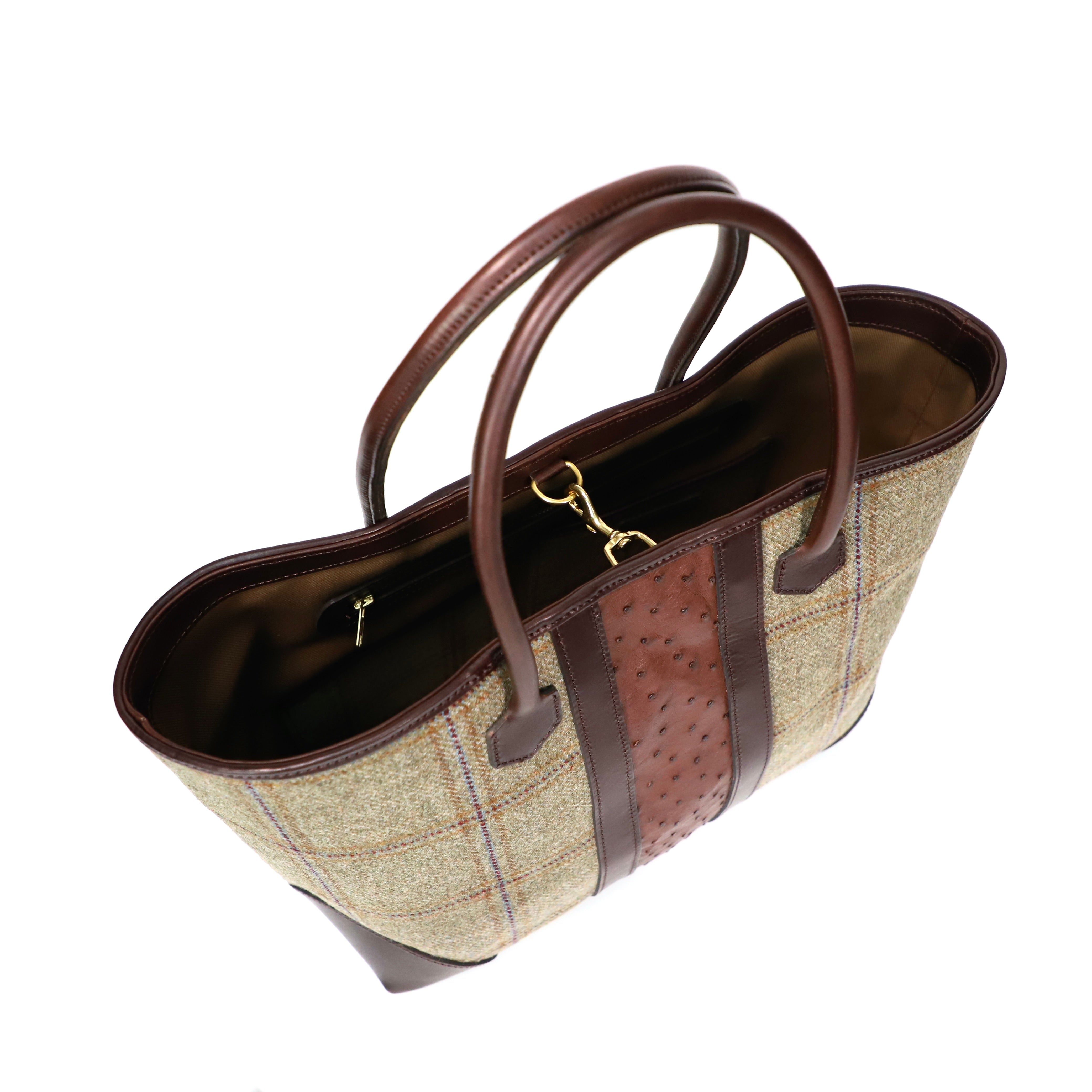 Handbag with plaid pattern and brown leather accents on a white background