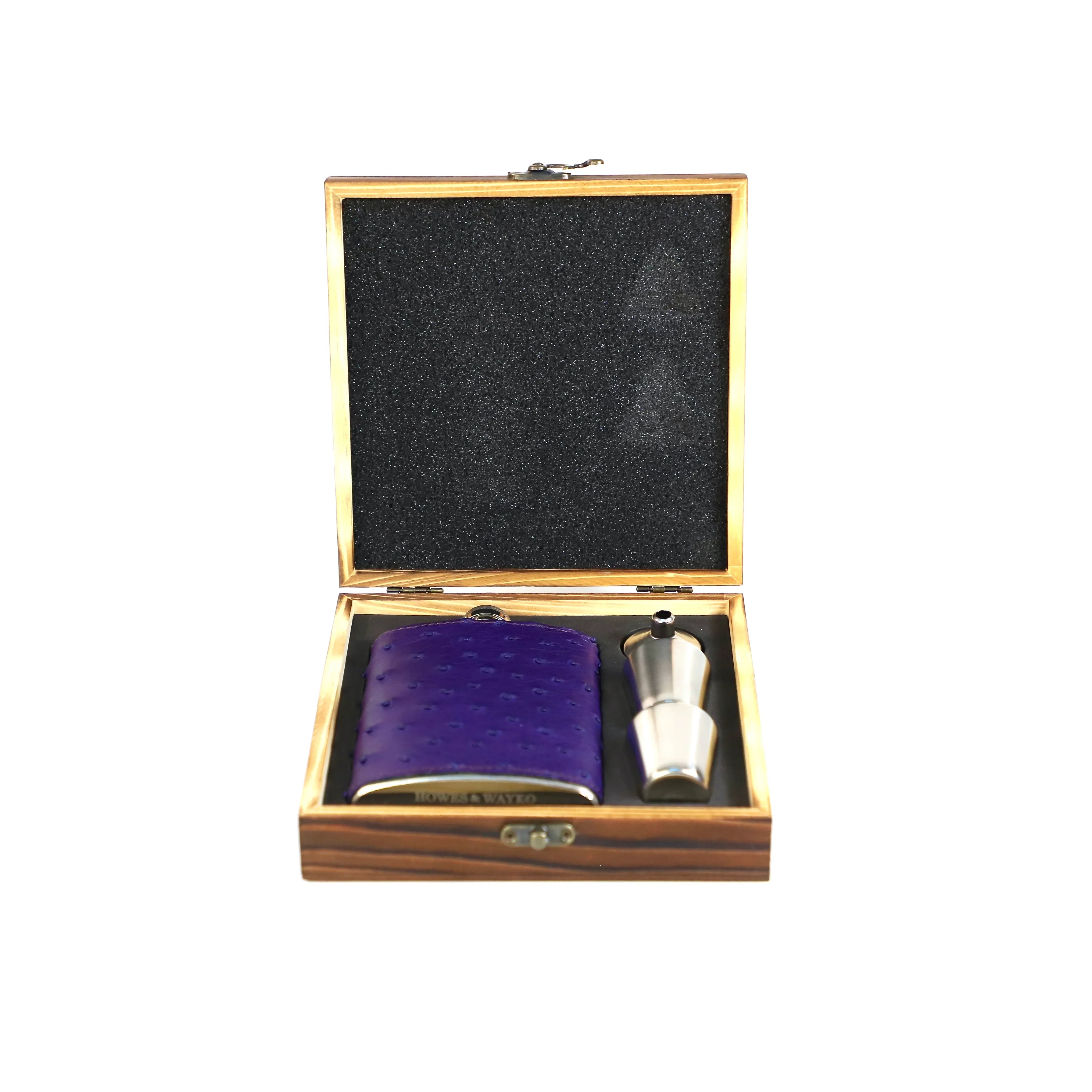 Purple pocket flask and silver funnel in a wooden box on a white background
