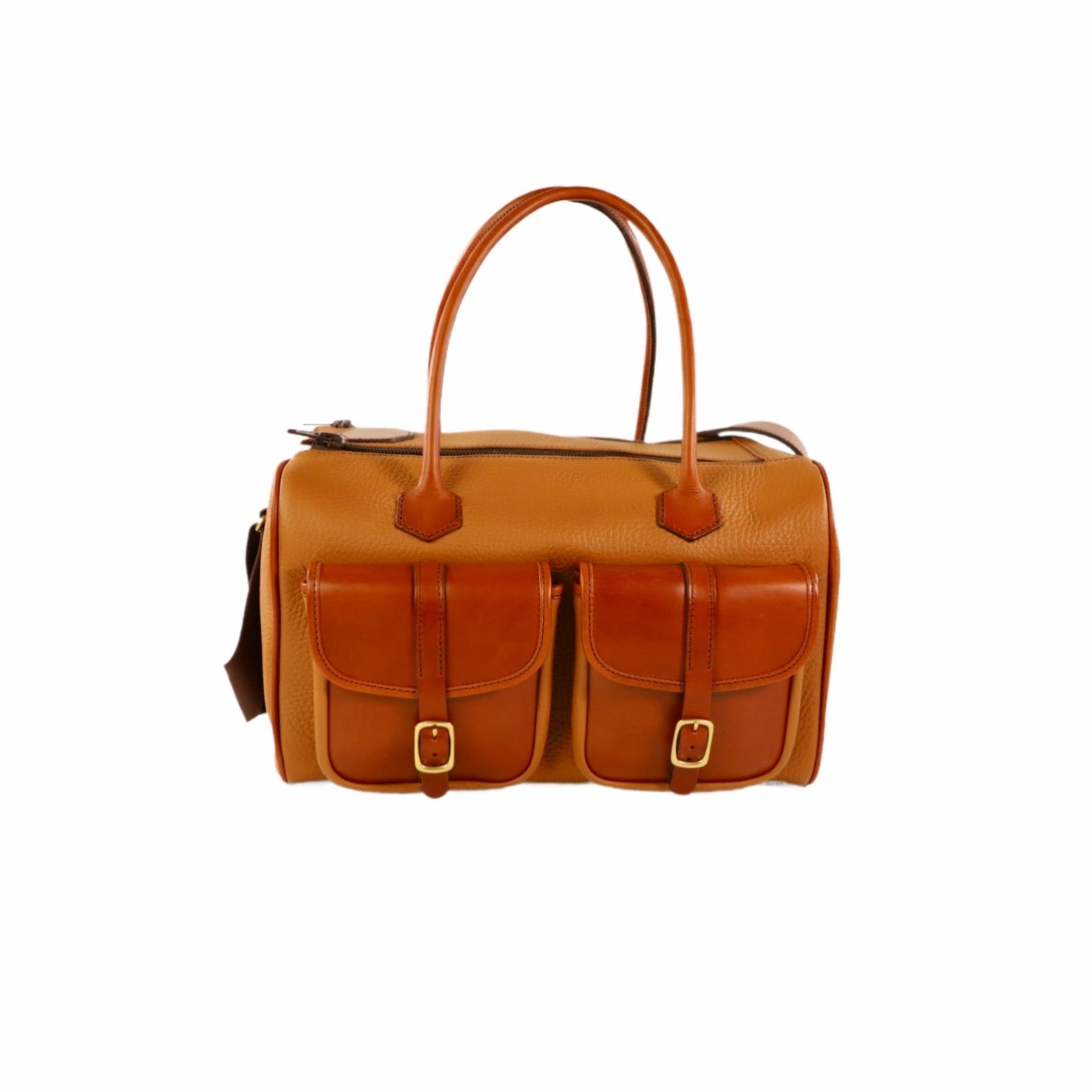 Tan leather bag with two front pockets and wide straps on a white background