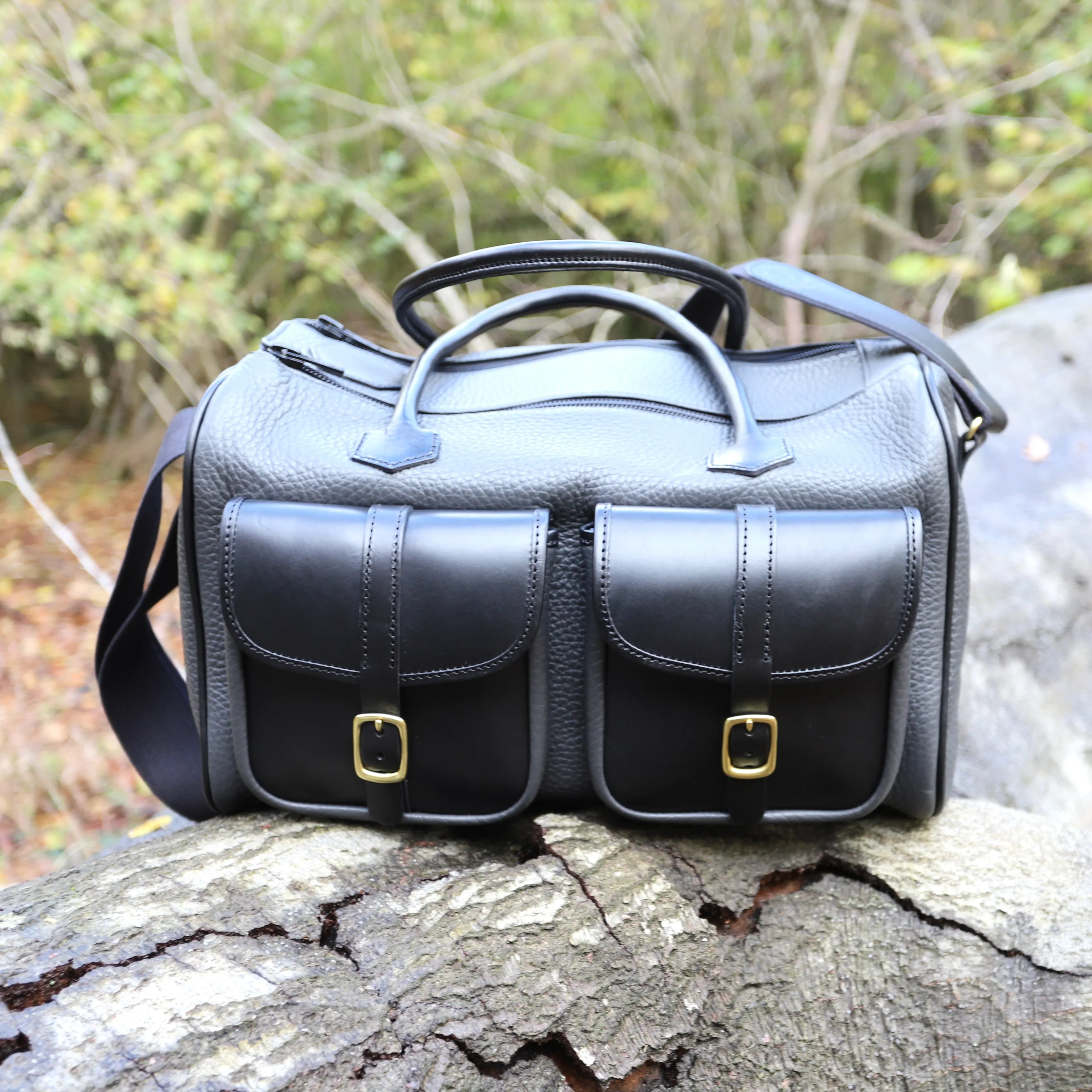 British Made Erin Greyson - Leather Range Bag side view of bag outdoors perched on a wooden log