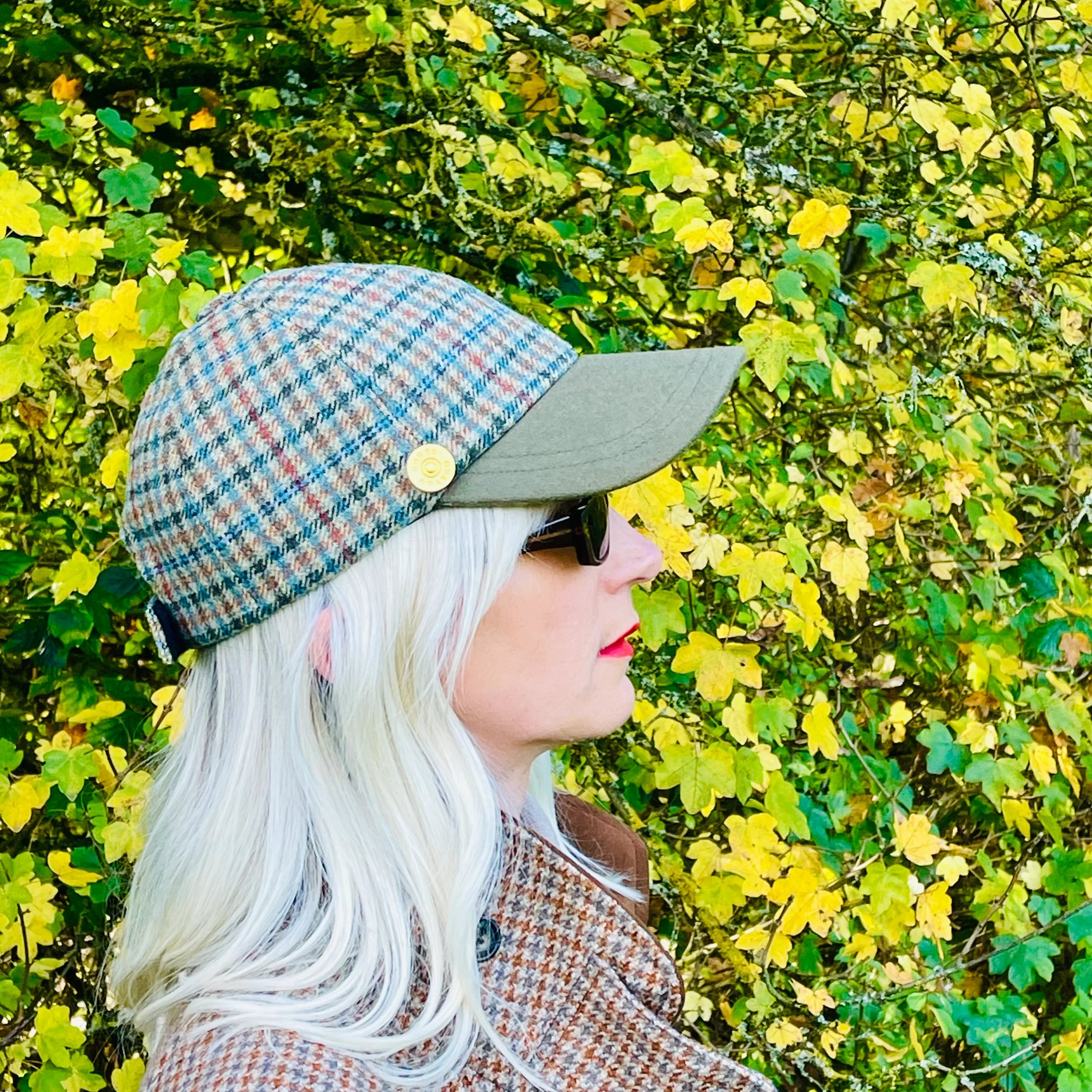 sage and red-checked British tweed worn by a woman outdoors
