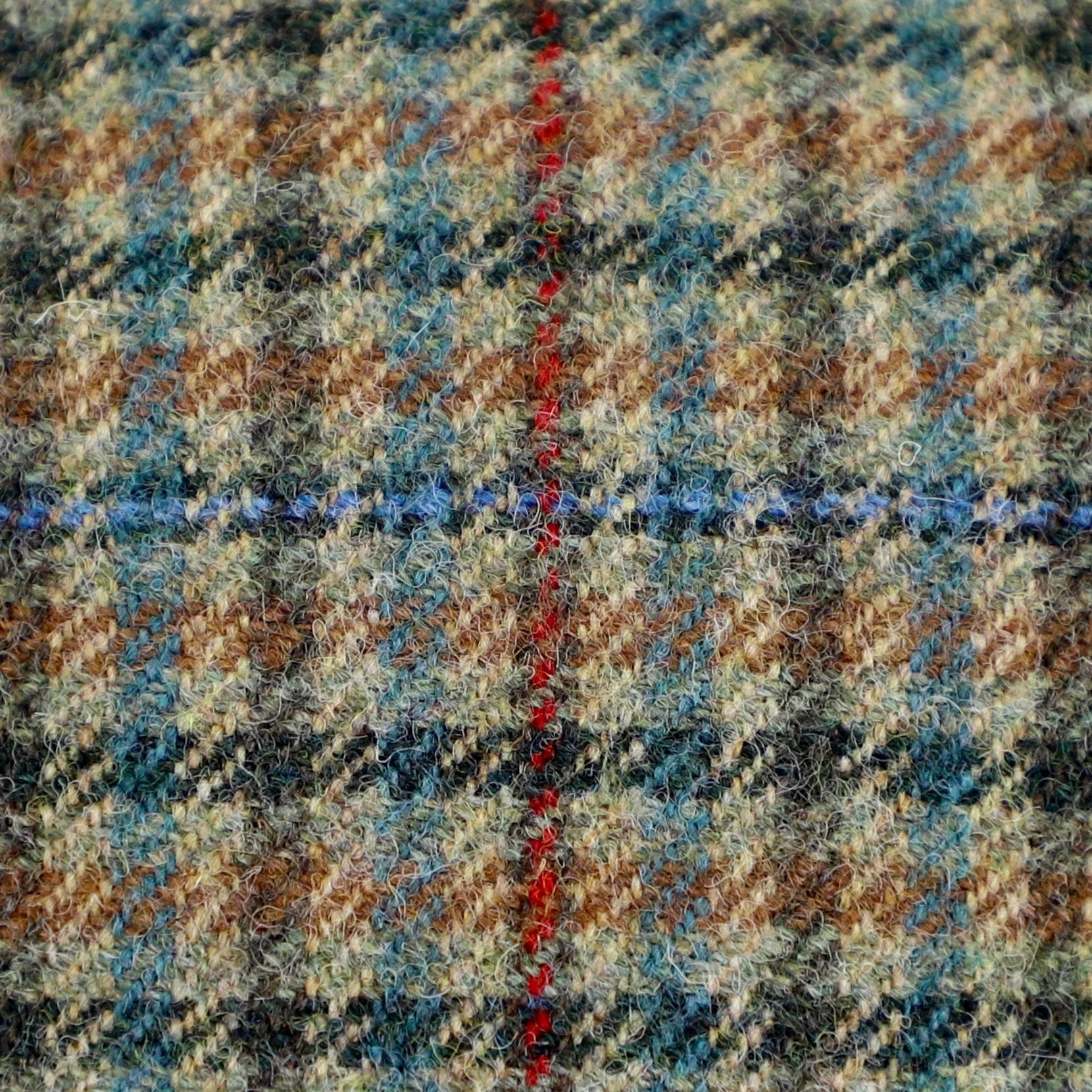 close up of sage and red-checked British tweed material