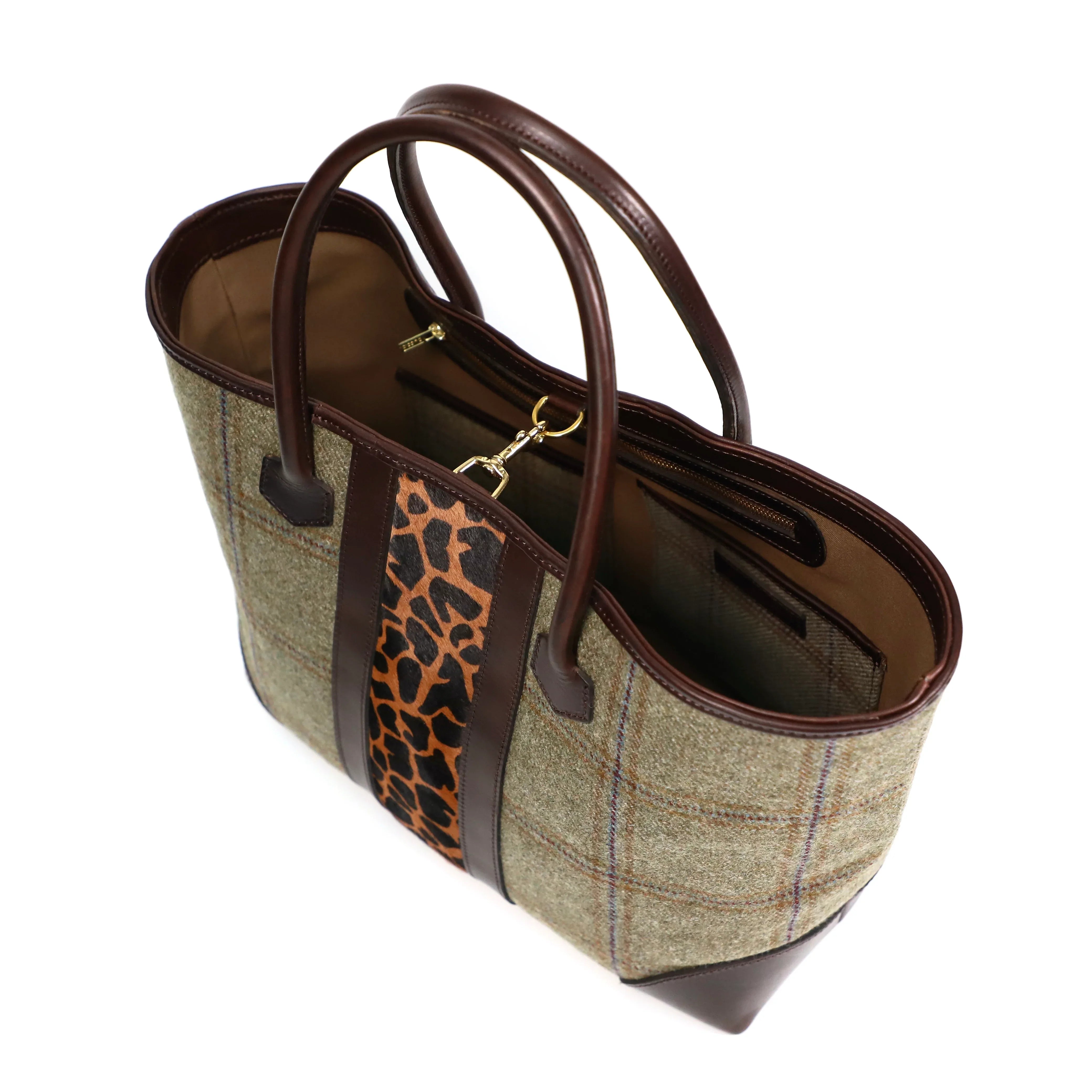 tote bag with plaid pattern and brown leather accents on a white background