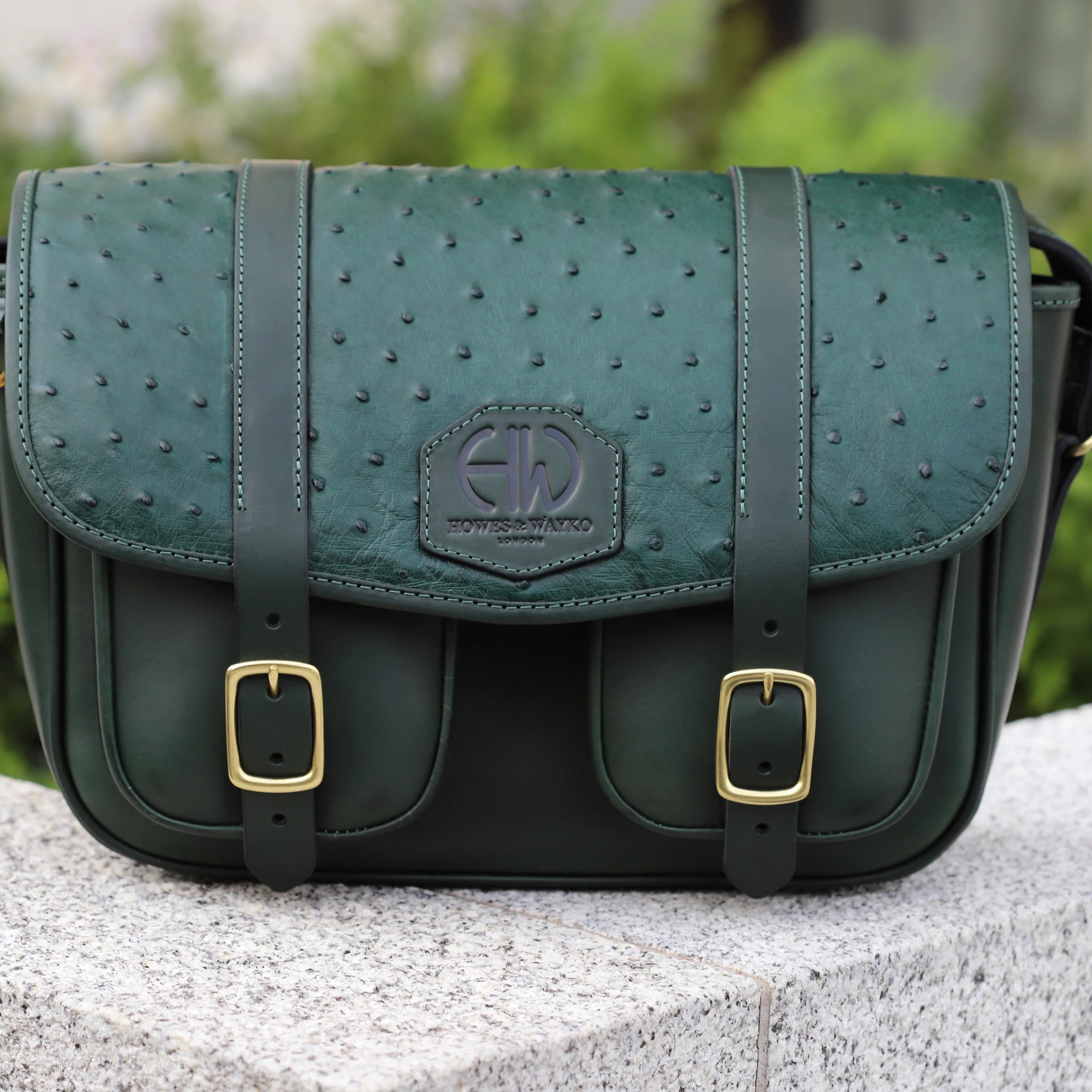 British Made Hera-Eden Green & Ostrich: Shooting Cartridge Bag main image of bag sitting on wall