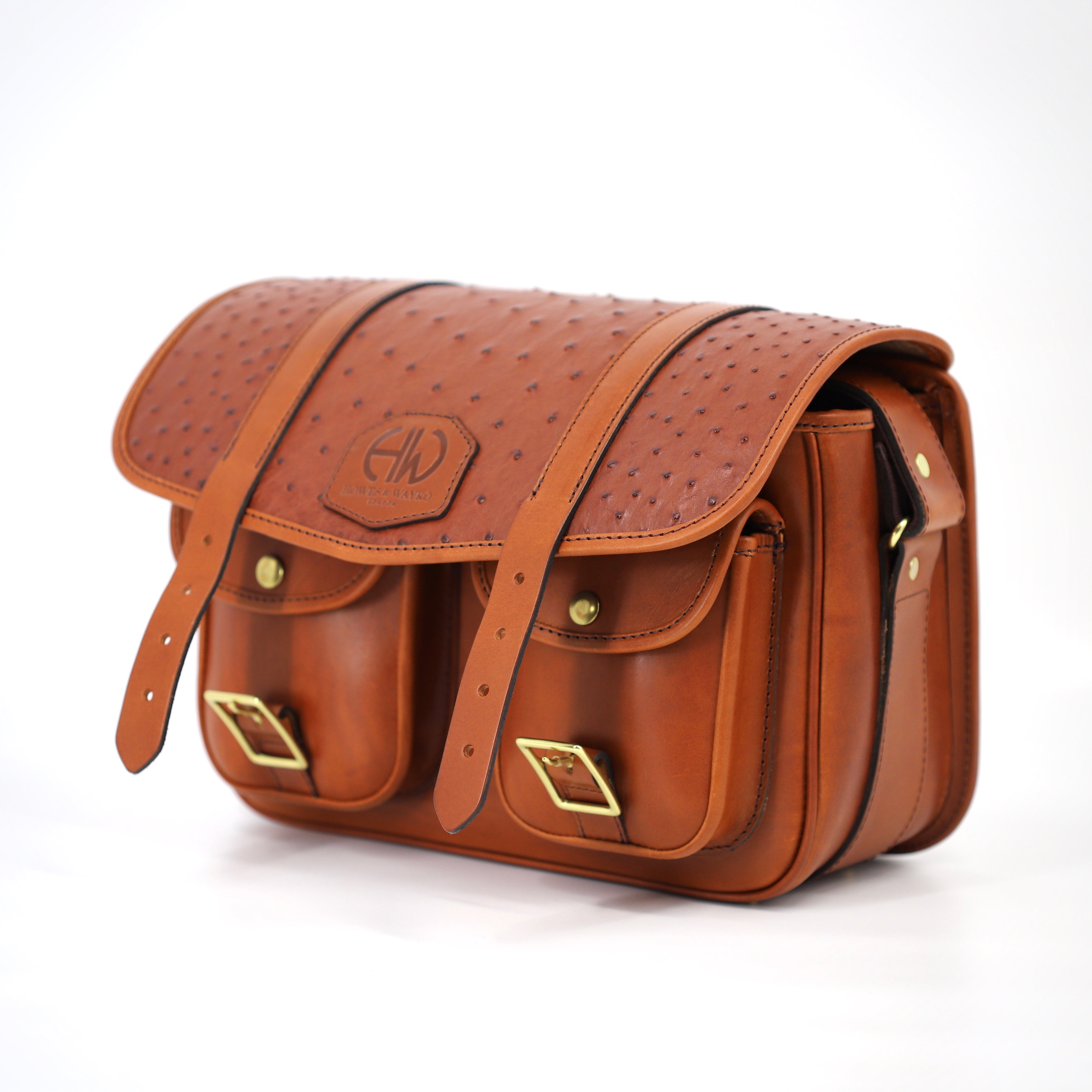 HERA-CHELSEA-OSTRICH CARTRIDGE BAG SIDE VIEW SHOWCASING UNBUCKLED YET CLOSED FLAP