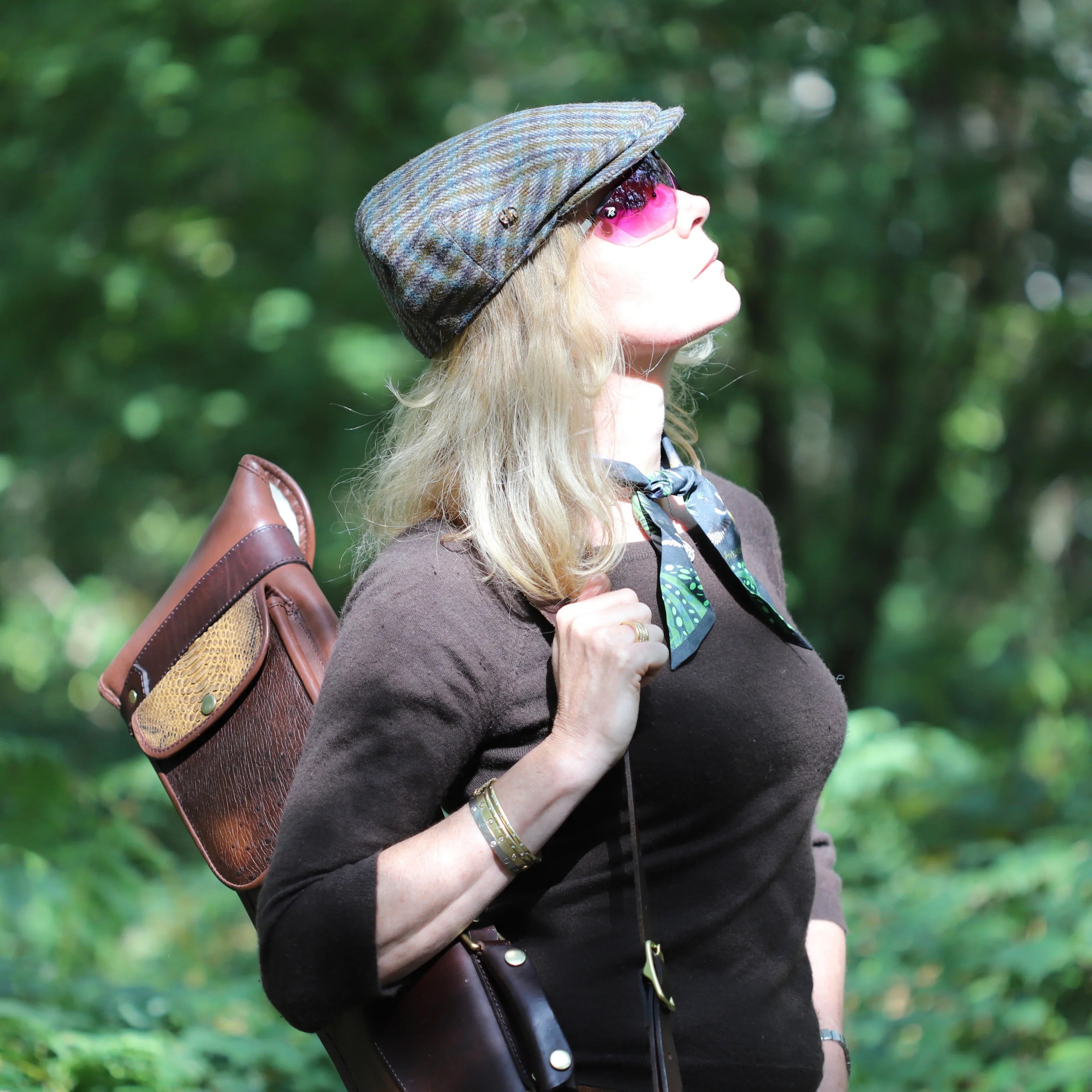 luna tweed cap shooting flat caps side view adorned on a woman in the field with other shooting accessories on