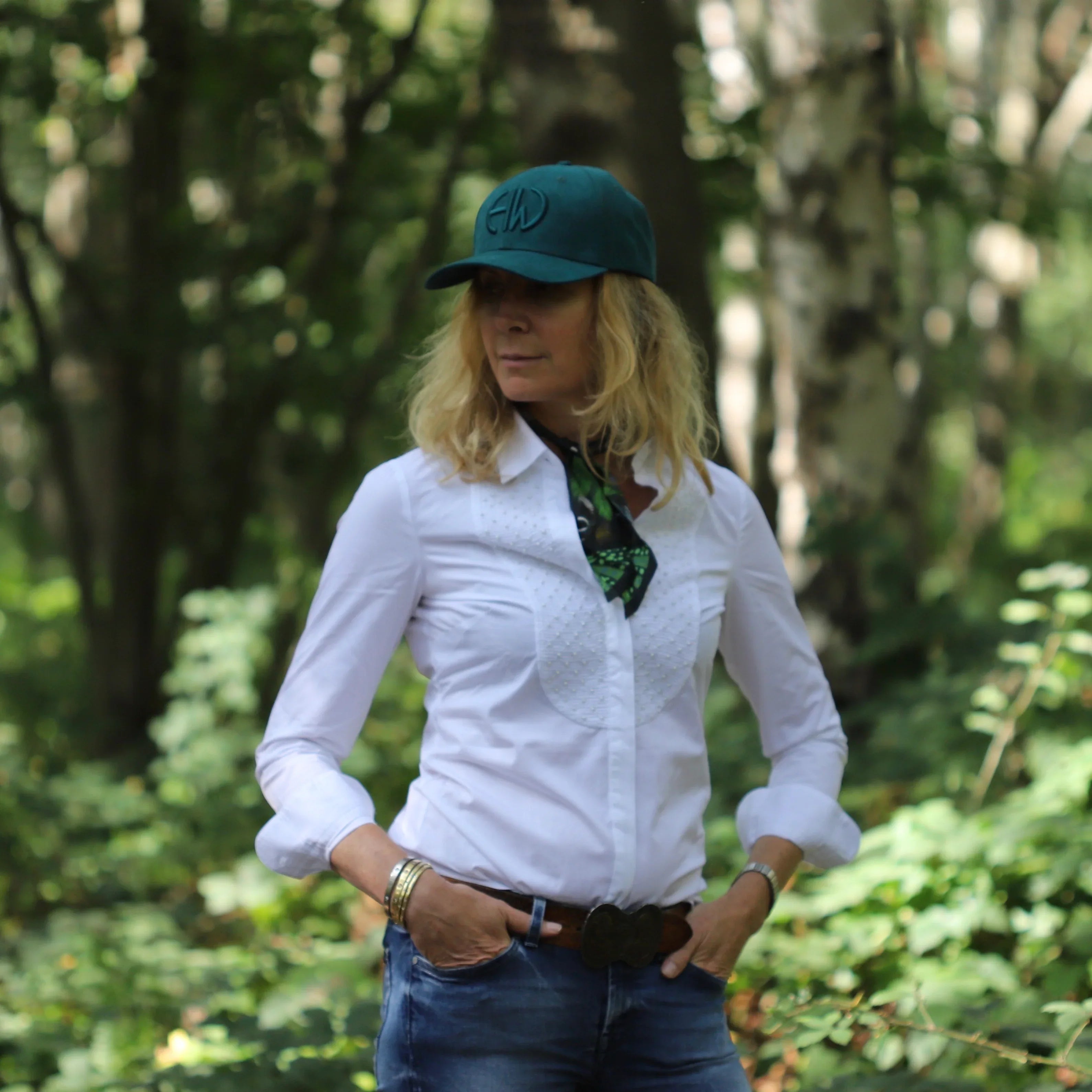 Iris Teal Shooting Baseball Cap - Shooting Accessories adorned on a woman in the outdoors, the woman is also wearing other shooting accessories