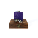 Purple  Ostrich flask displayed on top of a  wooden gift box on a white background