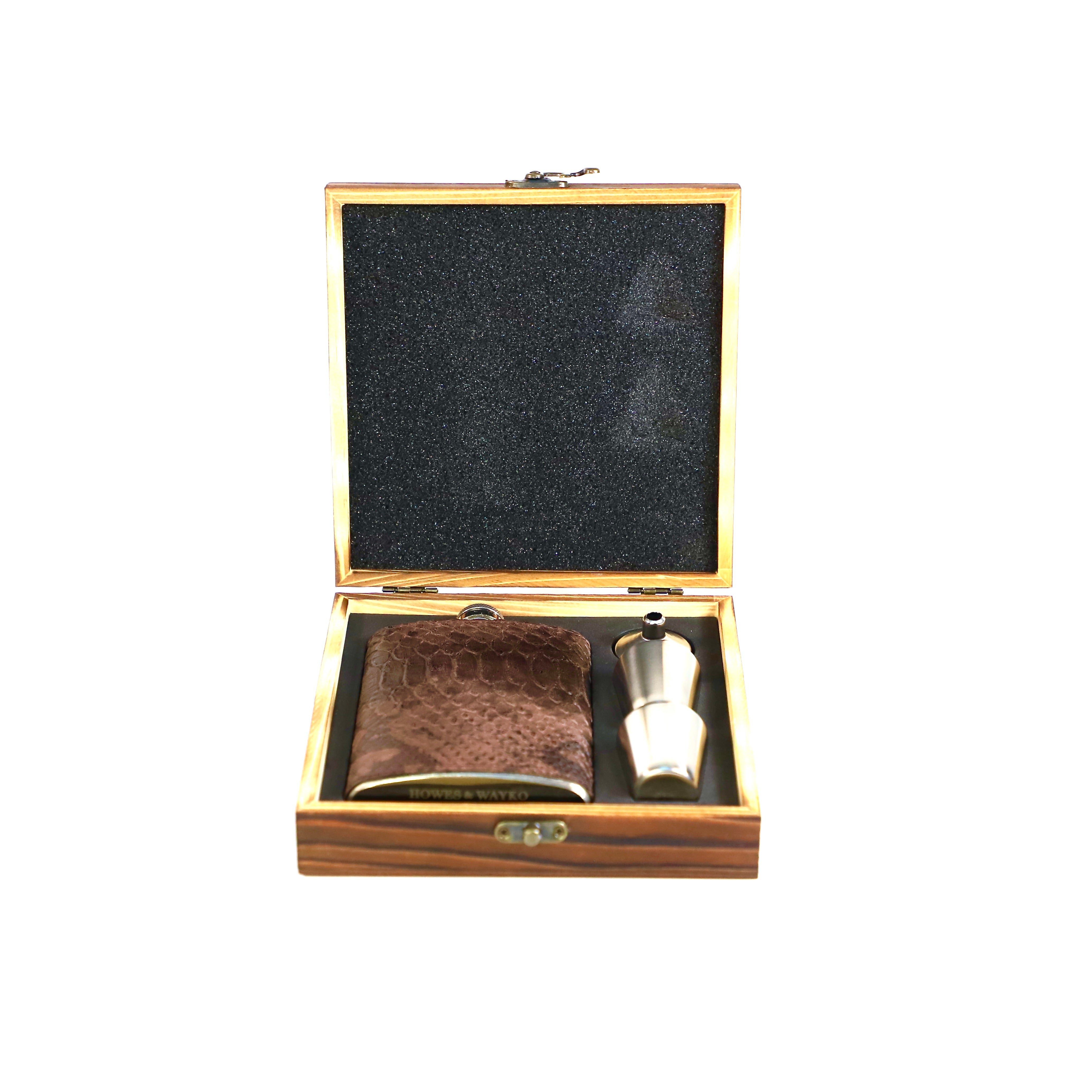 Stainless flask covered in a brown snake effect leather, displayed in a wooden gift box with  a white background.
