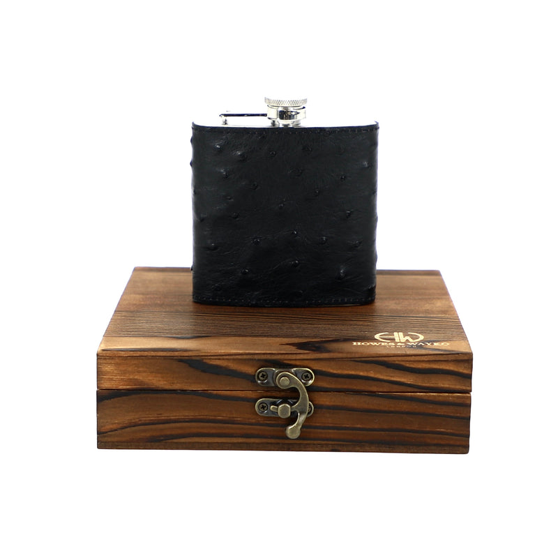 dark ostrich flask on top of wooden encasing