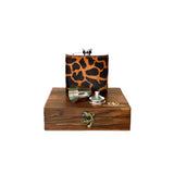 Flask with leopard print cover and wooden box on a white background