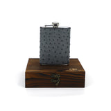 a luxury hip flask taller version sitting on its wooden box encasing