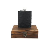 larger dark/black ostrich hip flask on top of wooden encasing