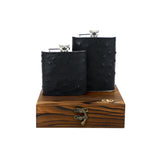 both black ostrich style hip flask sizes on top of wooden case