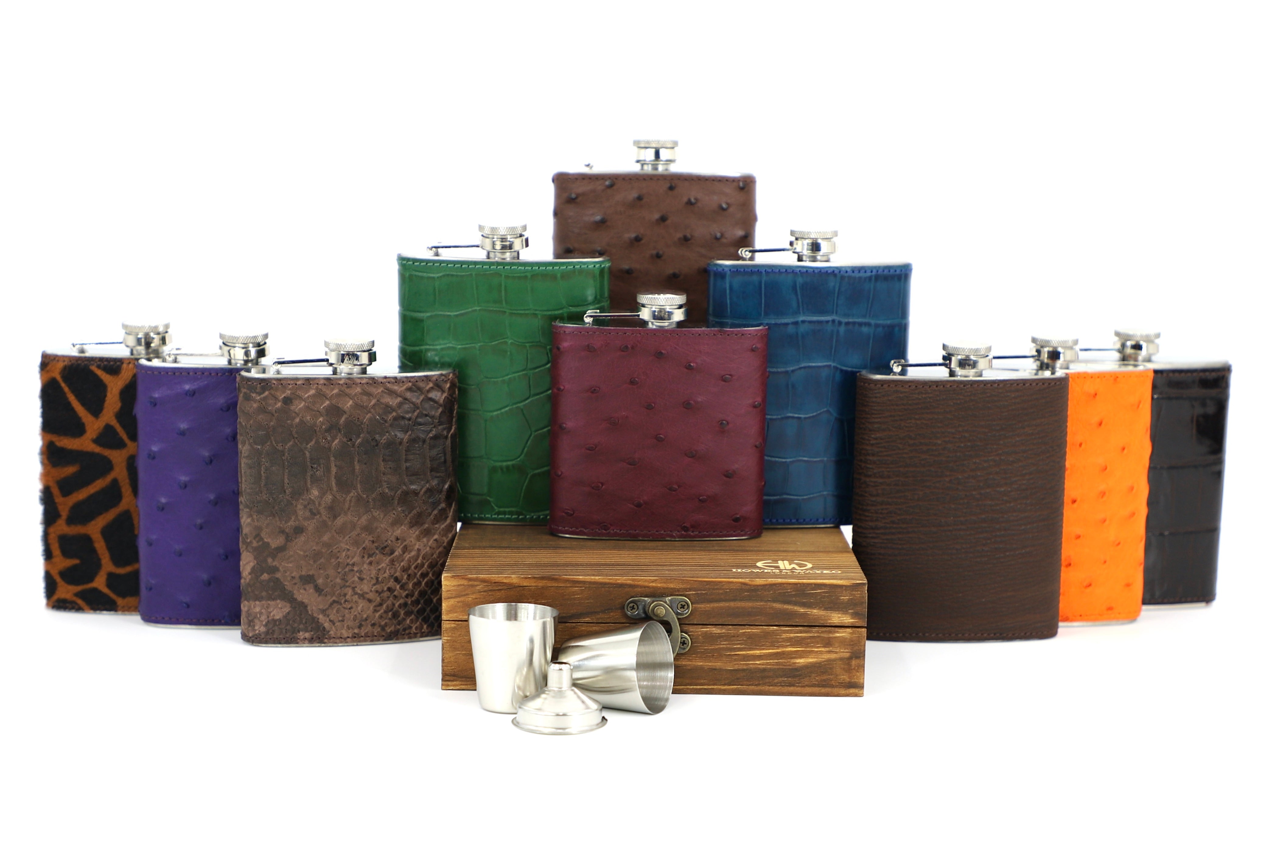 A display of Howes and Wayko Stainless steel flasks covered in array of vibrant exotic skins, displayed with a white background