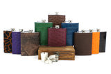 A display of Howes and Wayko Stainless steel flasks covered in array of vibrant exotic skins, displayed with a white background