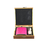 Pink leather flask and silver shaker in a wooden gift box on a white background