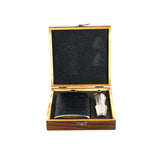 Hip flask covered in black Ostrich skin, displayed in a wooden gift box, alongside a pair of shot glasses and a funnel.