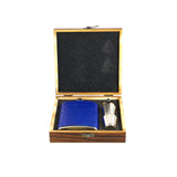 Blue flask and silver decanter set in a wooden box on a white background