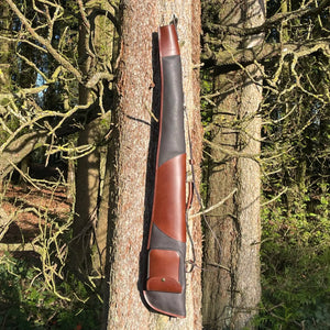 Leto Russet Gun Slip - Fleece Lined Leather Gun Protector showcased hanging up on a tree so gun slip is seen in full length