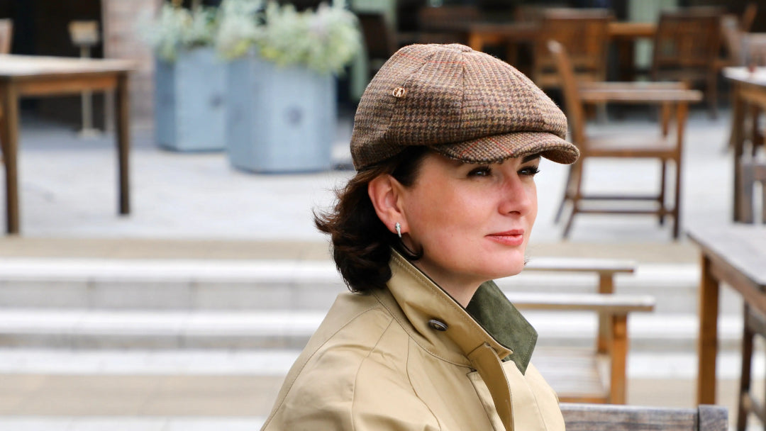 tweed cap uk showcased on a woman sitting on a bench in a public place