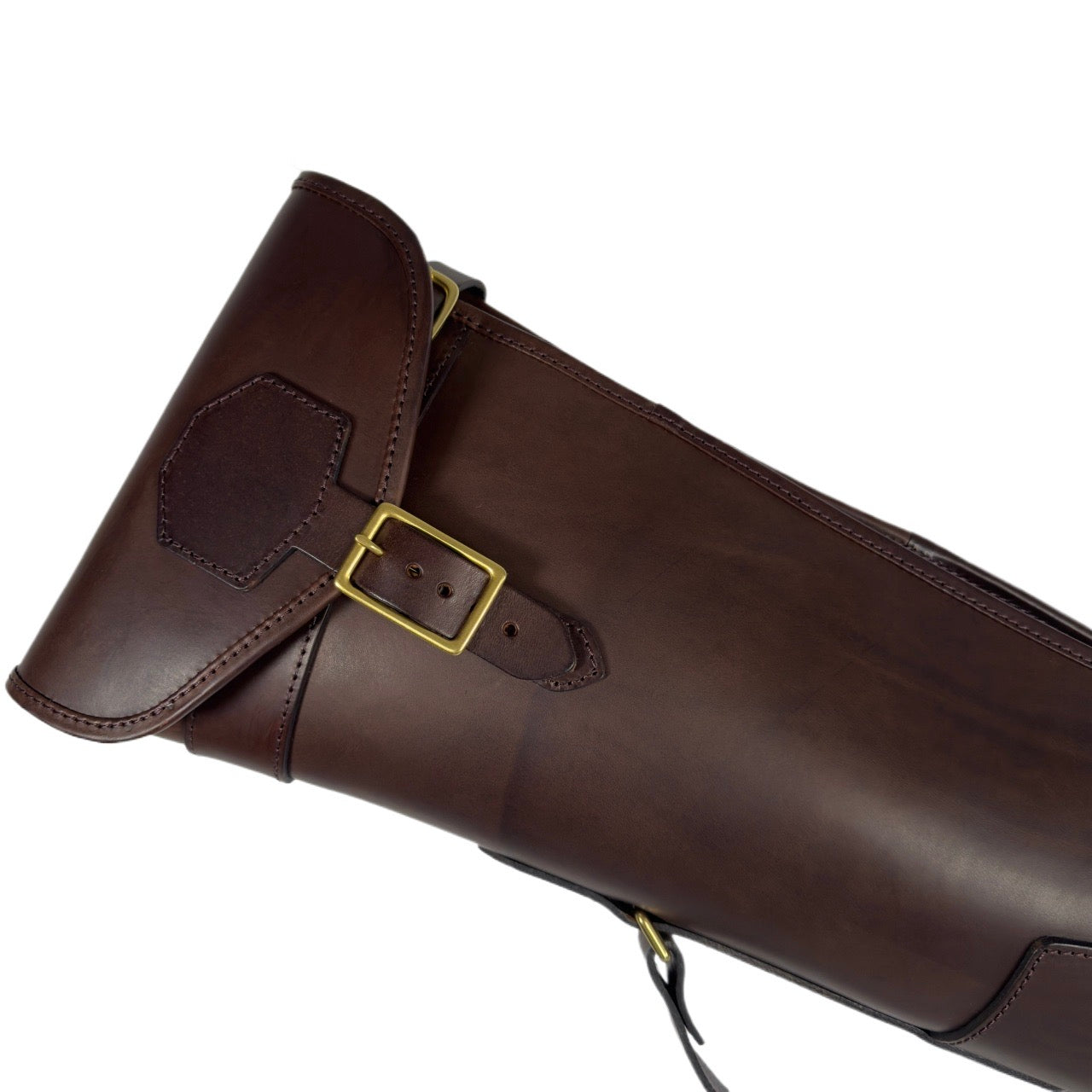 Brown leather gun case with a gold buckle on a white background