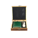 Green hip flask and silver decanter in an open wooden box on a white background