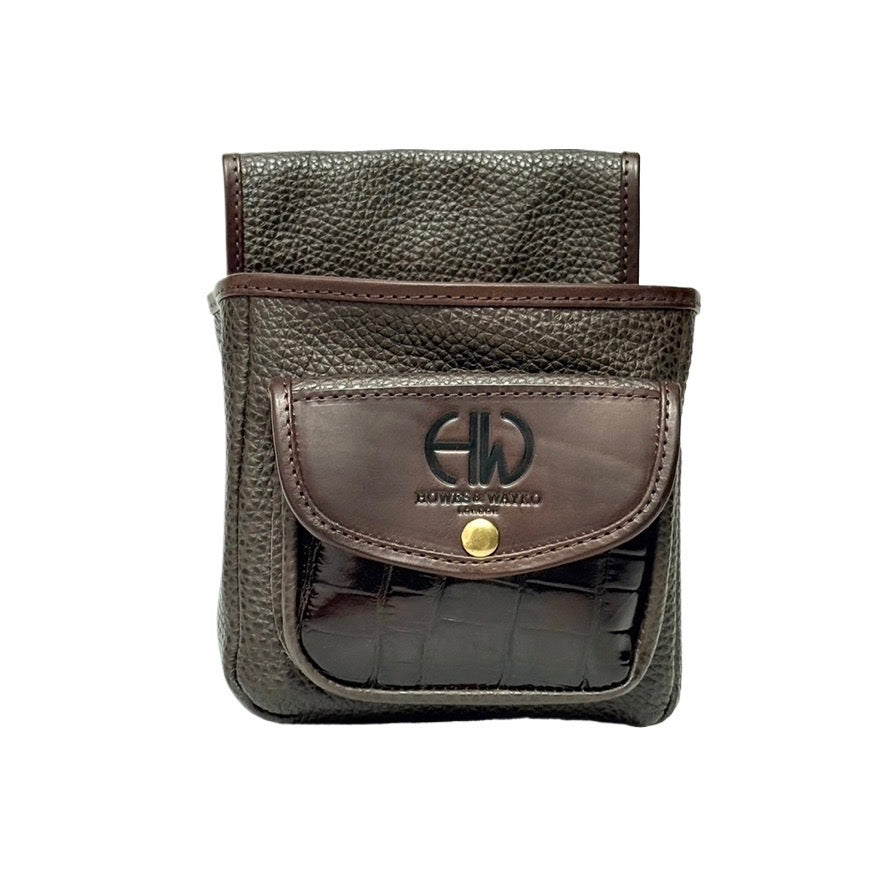 Brown leather pouch with a moc crocodile pocket  and a Howees and Wayko brand logo on a white background