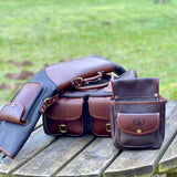 Leto Russet Gun Slip - Fleece Lined Leather Gun Protector on a wooden table in the outdoors with matching cartridge bag and cartridge pouch for a full set