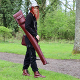 gun slip in oxblood italian leather over the shoulder of a woman in a shooting field endorsed with shooting accessories