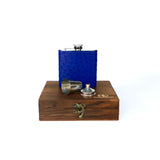 blue ostrich flask displayed on top of a dark brown wooden gift box