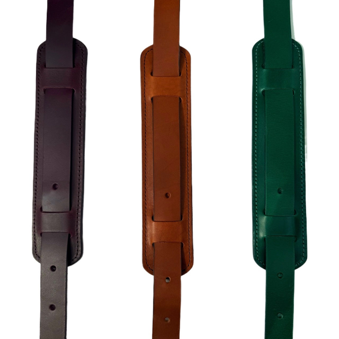 Three leather straps in brown, green, and black on a white background