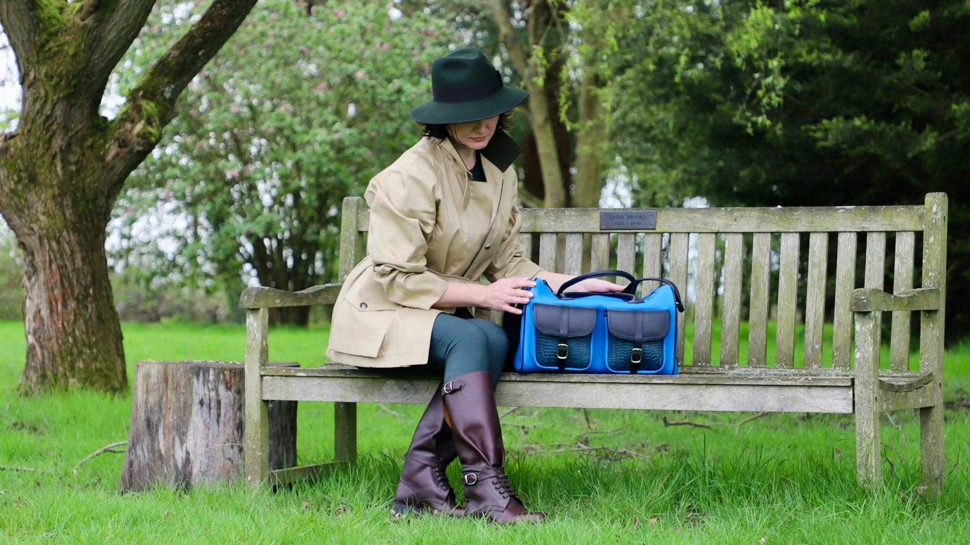 howes and wayko shooting accessories blue cartridge range bag on show with a woman in a park sitting on a bench