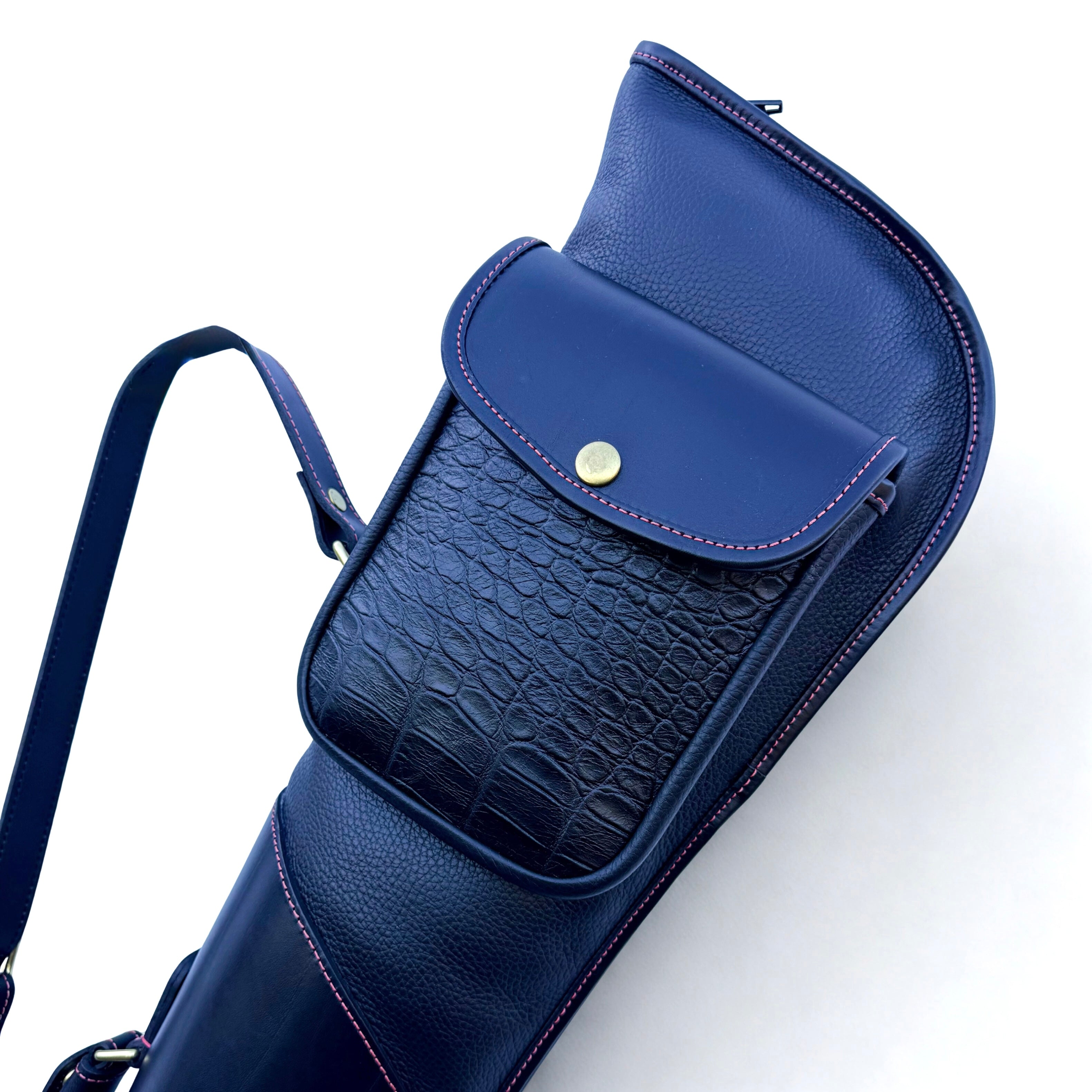 Blue leather gun slip with textured pocket on a white background