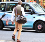 British Made Erin Brown Ostrich - Range Bag adorned by a man in London walking casually in the street