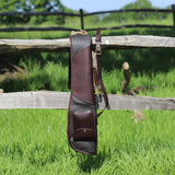 Leto Brown Gun Slip - Fleece Lined Leather Gun Protector folded over a wooden fence in the outdoors